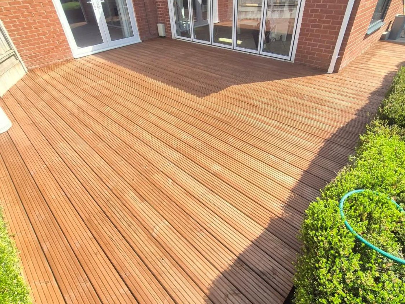 Restored golden timber deck after pressure washing