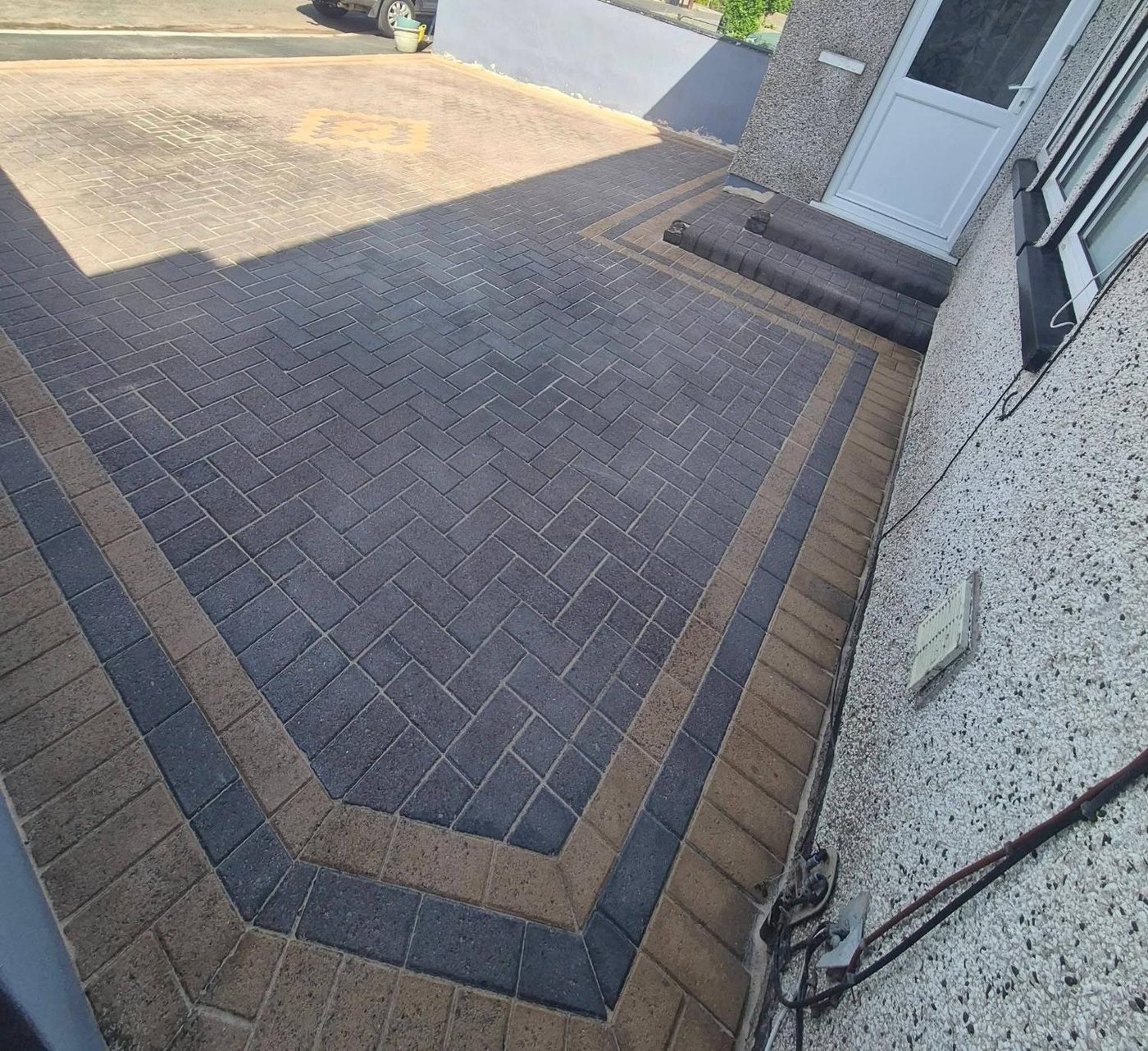 The same driveway after pressure washing, pattern restored